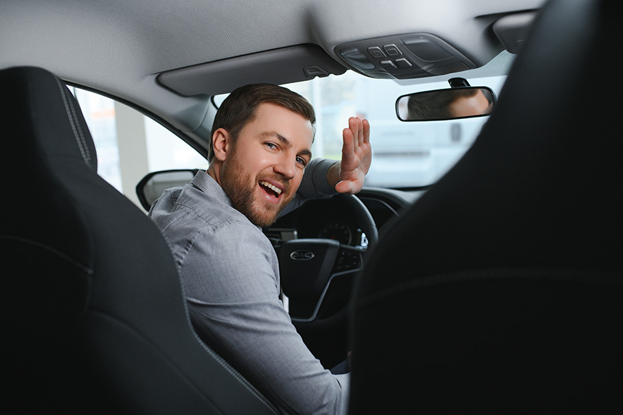 young-man-is-choosing-a-new-vehicle-in-autossey